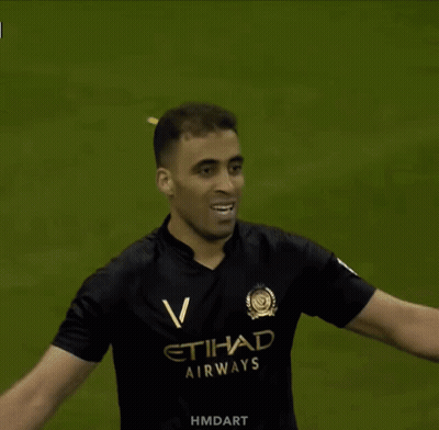 A Man In A Black Etihad Airways Jersey GIF