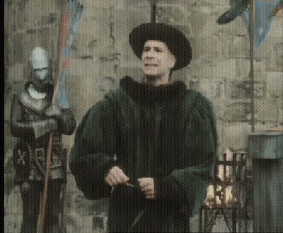 A Man In A Black Hat Is Holding A Sword GIF