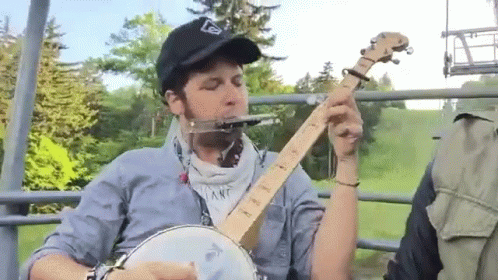 Man In Black Hat Playing Banjo On Chairlift GIF