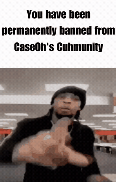 A Man In A Black Hat Is Pointing A Gun At The Camera . GIF