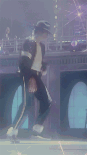 A Man In A Black Hat Is Standing In Front Of A Window GIF