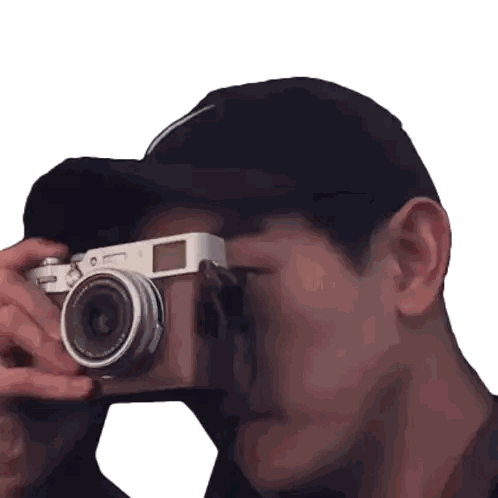 A Man In A Black Hat Is Taking A Picture With A Canon Camera Sticker