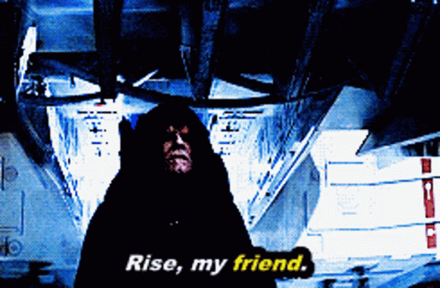 A Man In A Black Hood Says " Rise My Friend " GIF