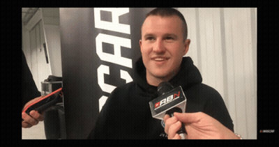 A Man In A Black Hoodie Is Being Interviewed By A Person Holding A Microphone That Says Cbn On It GIF