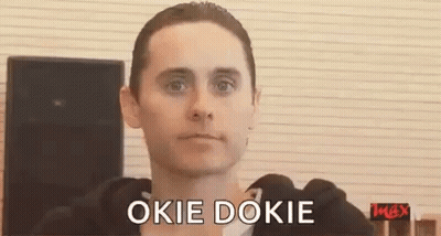 A Man In A Black Hoodie Is Making A Funny Face And Saying Okie Dokie . GIF