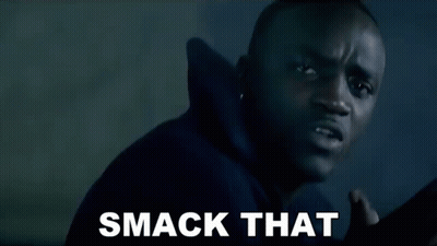 A Man In A Black Hoodie Is Making A Funny Face And The Words Smack That Are On The Screen Behind Him . GIF