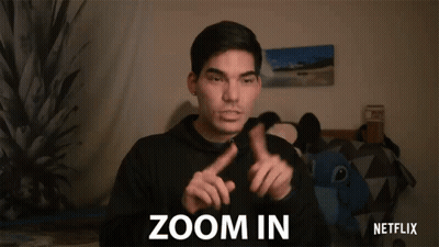 A Man In A Black Hoodie Is Making A Sign That Says Zoom In GIF
