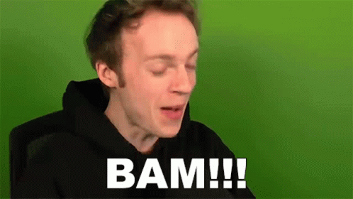 A Man In A Black Hoodie Is Sitting In Front Of A Green Screen And Says Bam ! GIF