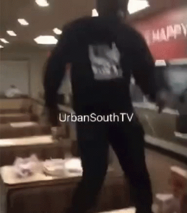 A Man In A Black Hoodie Is Standing In A Restaurant With Urbansouthtv Written On The Bottom Of The Image GIF