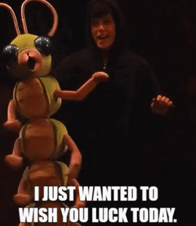 A Man In A Black Hoodie Is Standing Next To A Stuffed Animal That Says I Just Wanted To Wish You Luck Today . GIF
