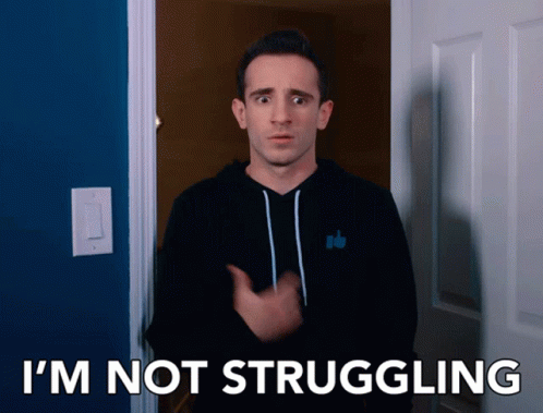 A Man In A Black Hoodie Says I 'M Not Struggling In Front Of A Blue Door GIF