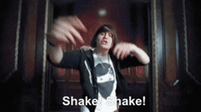 A Man In A Black Hoodie Says Shake Shake In A Dark Room GIF