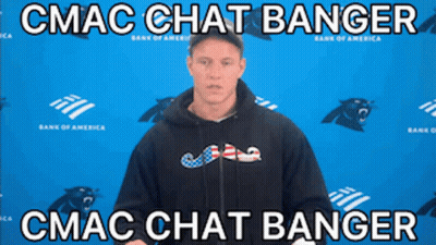 A Man In A Black Hoodie Stands In Front Of A Blue Wall With Panthers On It GIF