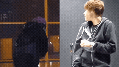 A Man In A Black Hoodie Stands Next To A Microphone GIF