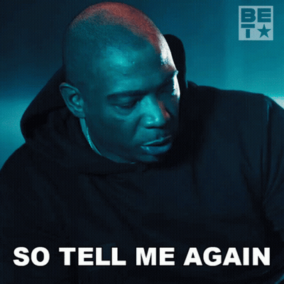 A Man In A Black Hoodie With The Words So Tell Me Again Written Below Him GIF