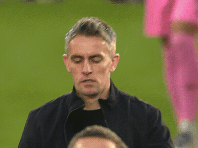 A Man In A Black Jacket Has A Button On His Jacket That Says ' United ' GIF