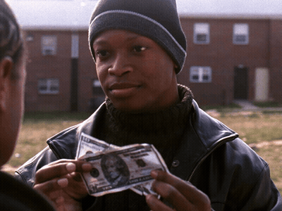 A Man In A Black Jacket Holds Up A 10 Dollar Bill GIF
