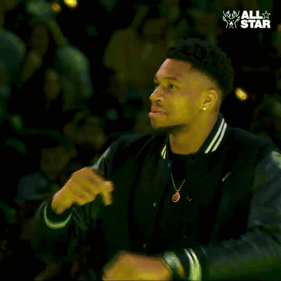 A Man In A Black Jacket Is Dancing In Front Of A Crowd With The Words " All Star " On The Bottom GIF