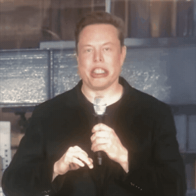 A Man In A Black Jacket Is Holding A Microphone GIF