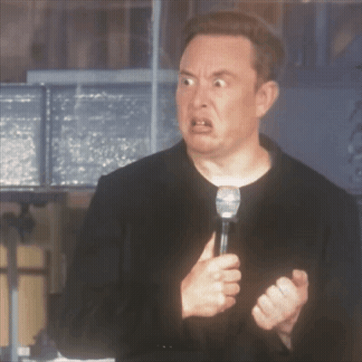 A Man In A Black Jacket Is Holding A Microphone And Making A Funny Face GIF