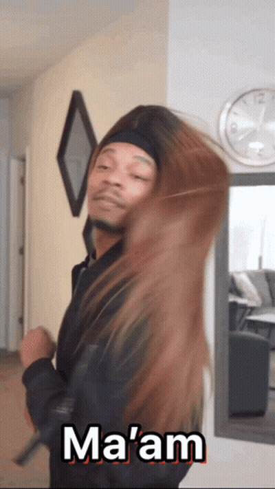 A Man In A Black Jacket Is Holding A Woman 'S Hair And Says Ma 'Am GIF