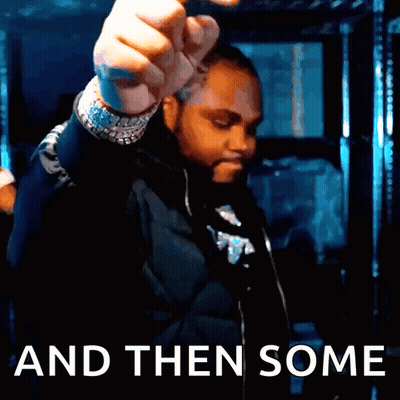 A Man In A Black Jacket Is Holding His Fist Up In Front Of The Words And Then Some GIF