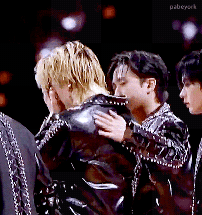 A Man In A Black Jacket Is Hugging Another Man In A Black Jacket GIF