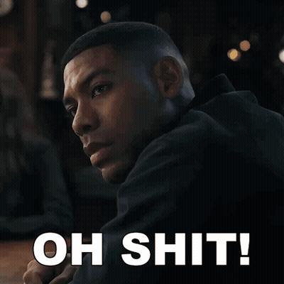 A Man In A Black Jacket Is Looking Over His Shoulder With The Words Oh Shit Written Below Him GIF