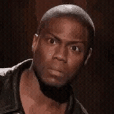 A Man In A Black Jacket Is Making A Funny Face . GIF