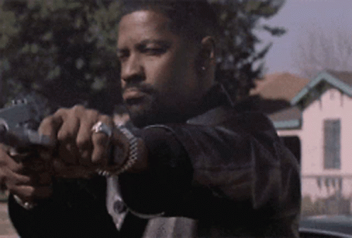 A Man In A Black Jacket Is Pointing A Gun At The Camera GIF