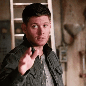 A Man In A Black Jacket Is Pointing His Finger At Something . GIF