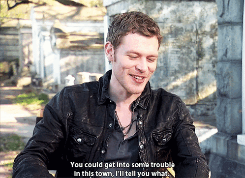 A Man In A Black Jacket Is Smiling And Saying " You Could Get Into Some Trouble In This Town I 'Ll Tell You What " GIF