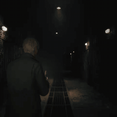 A Man In A Black Jacket Is Standing In A Dark Room GIF