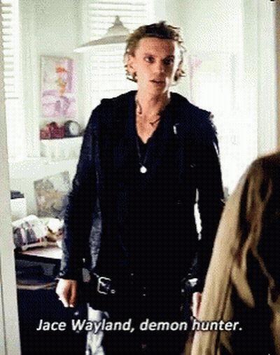 A Man In A Black Jacket Is Standing Next To A Woman And Says Jace Wayland Demon Hunter . GIF