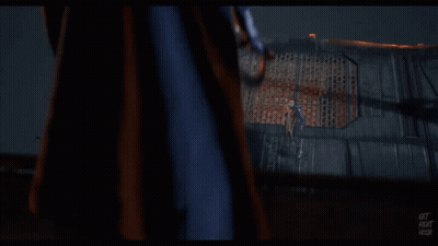 A Man In A Black Jacket Is Standing Next To Another Man In A Black Suit GIF