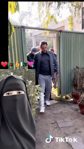 A Man In A Black Jacket Is Walking Through A Gate Next To A Woman In A Niqab And A Tiktok Logo GIF