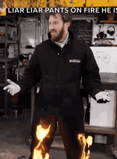 A Man In A Black Jacket Is Wearing Flaming Pants GIF