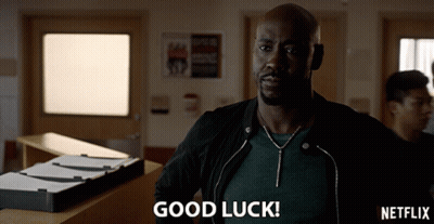 A Man In A Black Jacket Says Good Luck In Front Of A Netflix Logo GIF