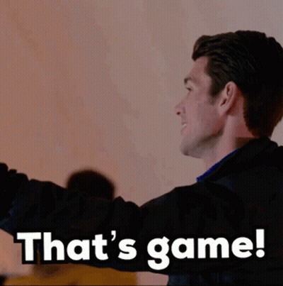 A Man In A Black Jacket Says That 'S Game While Standing In Front Of A Wall GIF