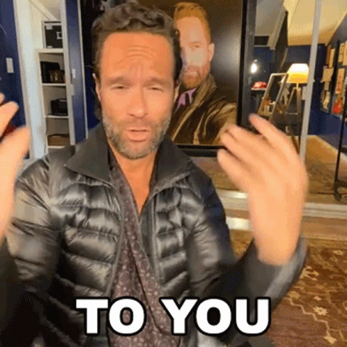 A Man In A Black Jacket Says " To You " GIF