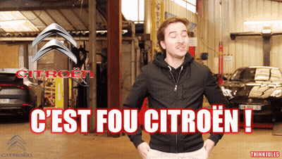 A Man In A Black Jacket Stands In Front Of A Citroen Logo GIF