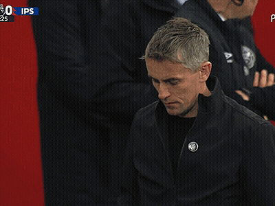 A Man In A Black Jacket Stands In Front Of A Sign That Says Ips On It GIF