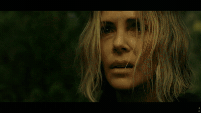 A Man In A Black Jacket Stands In The Woods GIF