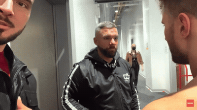 A Man In A Black Jacket With A Crown On It GIF