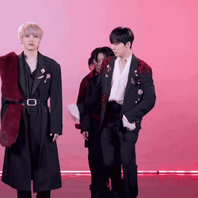 A Man In A Black Jacket With A Red Fur Collar GIF