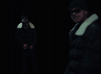A Man In A Black Jacket With A White Fur Collar GIF