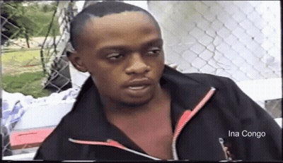 A Man In A Black Jacket With The Name Ina Congo On The Bottom Right GIF