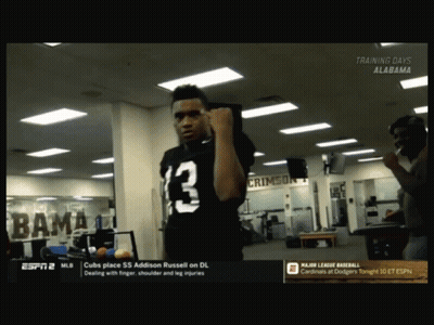 A Man In A Black Jersey With The Number 13 On It Stands In A Gym GIF