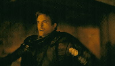 A Man In A Black Leather Jacket Is Flying In The Air GIF
