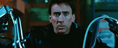 A Man In A Black Leather Jacket Is Holding A Pair Of Motorcycle Handlebars GIF